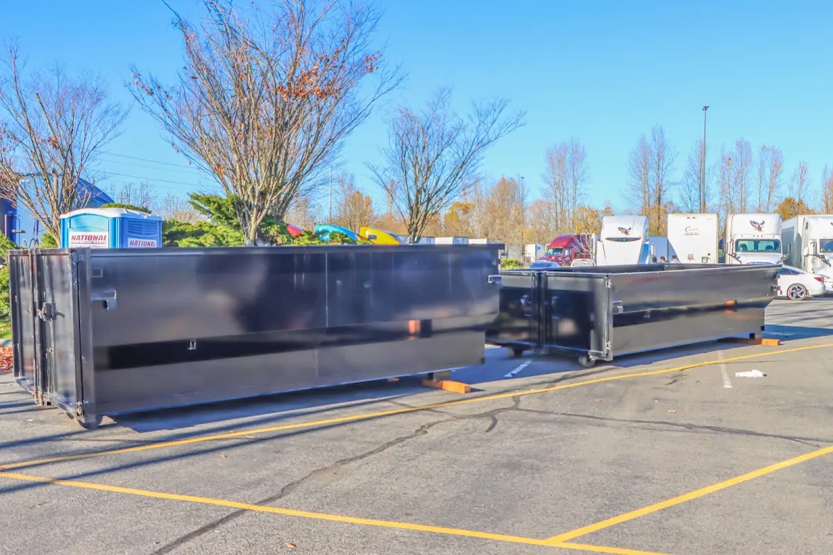 Professional dumpster rental service with roll-off container on residential driveway in Walnut